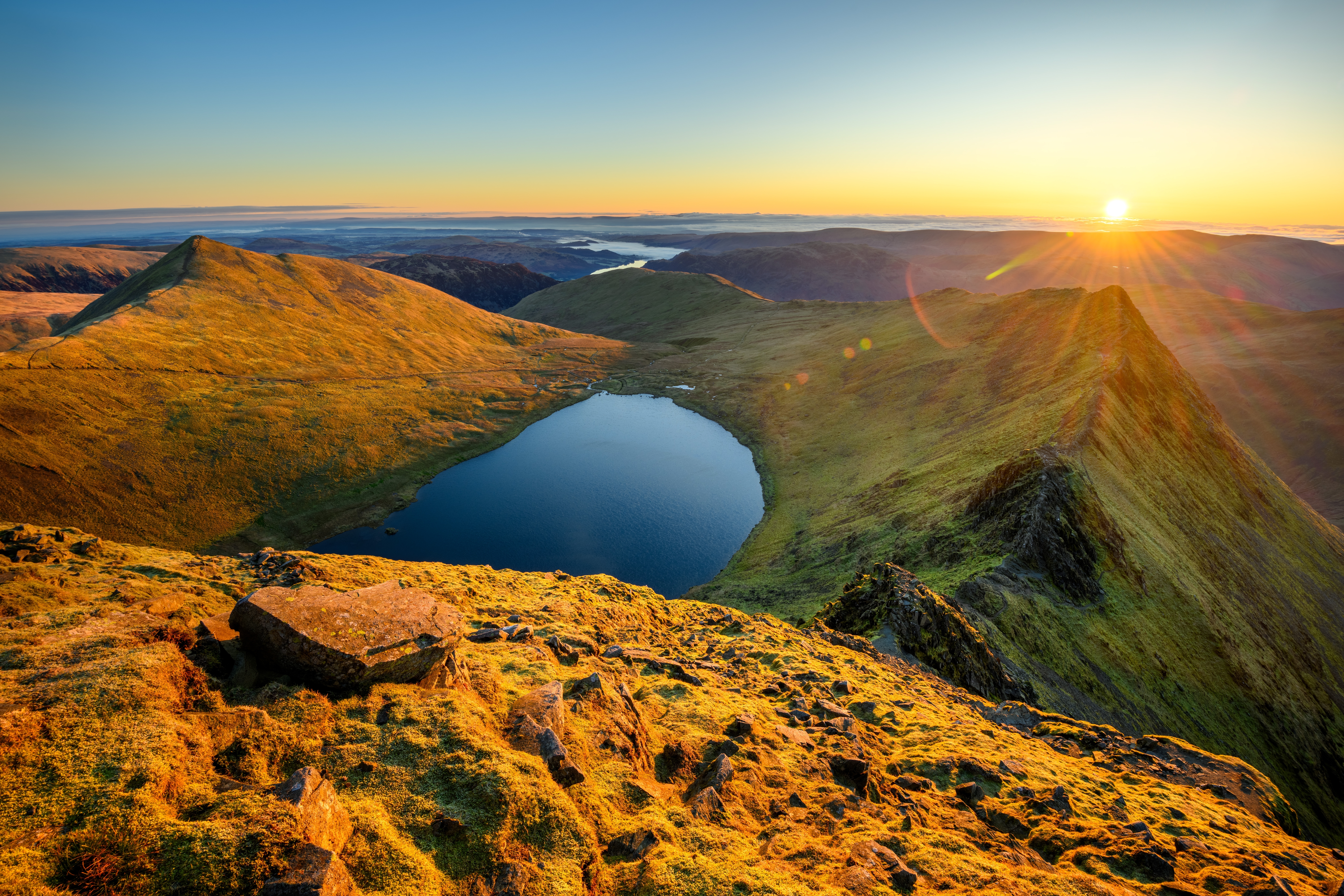 golden sunrise from helvellyn in the lake district overlooking striding edge and ullswater 2