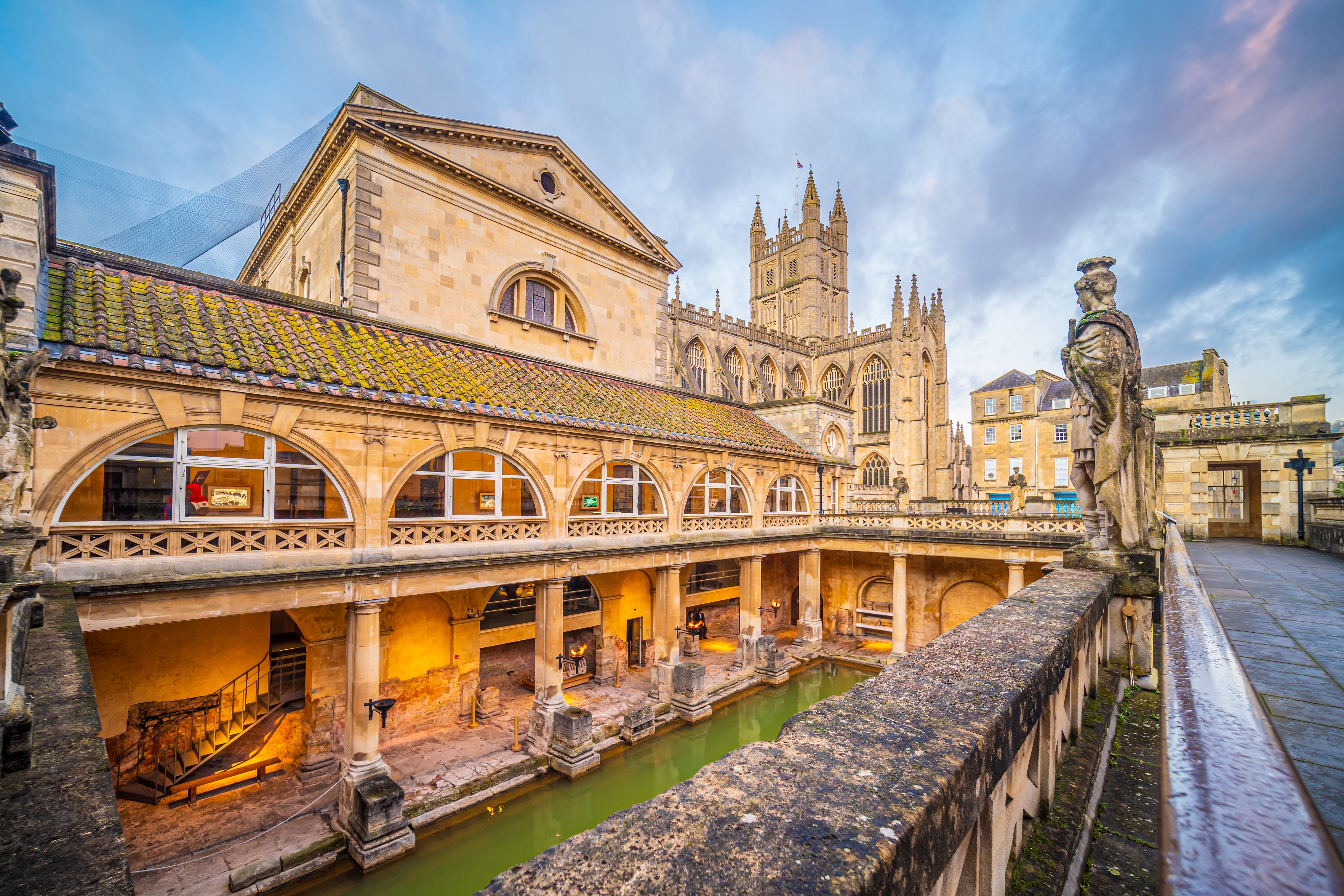 historical roman bathes in bath city england at twilight